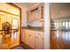 Wet bar with cabinets and granite counters sits next to a sun-filled dining room with chandelier at 6013 Yellow Birch Ct, Avon, IN 46123