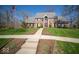 Beautiful red brick home with manicured lawn and landscaped beds and an American flag at 6013 Yellow Birch Ct, Avon, IN 46123