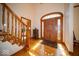 Inviting foyer with hardwood floors, detailed trim and a wooden staircase at 6013 Yellow Birch Ct, Avon, IN 46123