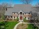 Elegant brick home with a well-maintained lawn and a welcoming front entrance enhanced by green landscaping at 6013 Yellow Birch Ct, Avon, IN 46123