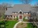 Charming brick home with lush green lawn and manicured bushes accenting the well-designed landscaping at 6013 Yellow Birch Ct, Avon, IN 46123