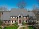 Stately brick home with manicured lawn, beautiful landscaping, and a classic front entrance at 6013 Yellow Birch Ct, Avon, IN 46123
