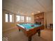 Finished basement game room with a pool table, brick fireplace, and natural light from the windows at 6013 Yellow Birch Ct, Avon, IN 46123