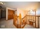 Landing area with a chandelier, hardwood railing, and access to all rooms at 6013 Yellow Birch Ct, Avon, IN 46123