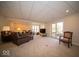 Spacious living room with plush seating, neutral carpet, and sliding glass doors leading to an outdoor deck at 6013 Yellow Birch Ct, Avon, IN 46123