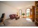 Bright sunroom or living room with built-in bookcase and large windows that let in plenty of light at 6013 Yellow Birch Ct, Avon, IN 46123