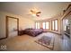 Spacious carpeted main bedroom featuring many large windows, ceiling fan, fireplace, and ensuite access at 6013 Yellow Birch Ct, Avon, IN 46123