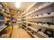 Organized wine cellar with white shelves and tile flooring offering ample storage space for wine and pantry goods at 6013 Yellow Birch Ct, Avon, IN 46123