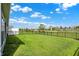 Backyard with a green lawn, bordered by a black fence, enhancing the property's outdoor appeal and security at 6026 Rockdell Dr, Indianapolis, IN 46237
