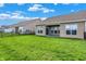 This spacious backyard shows a lush lawn, and partial fencing offering privacy and space for outdoor activities at 6026 Rockdell Dr, Indianapolis, IN 46237