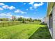This large backyard is fenced and shows an expansive green lawn for various outdoor activities and enjoyment at 6026 Rockdell Dr, Indianapolis, IN 46237