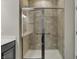 Updated bathroom with glass shower doors and tiled walls at 6026 Rockdell Dr, Indianapolis, IN 46237