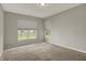 Bright bedroom with carpet, two windows, and neutral walls at 6026 Rockdell Dr, Indianapolis, IN 46237