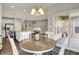 The breakfast area is off the kitchen, featuring a round table and access to a screened in porch at 6026 Rockdell Dr, Indianapolis, IN 46237