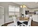 Eat-in kitchen features a round table with access to a window, chandelier, and a view of the kitchen at 6026 Rockdell Dr, Indianapolis, IN 46237