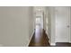 Spacious hallway features hardwood floors and light gray walls leading into the main living areas at 6026 Rockdell Dr, Indianapolis, IN 46237
