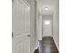 Hallway features hardwood floors and a white front door with glass panel at 6026 Rockdell Dr, Indianapolis, IN 46237