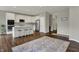 Modern kitchen features white cabinetry, stainless steel appliances, and a center island with bar seating at 6026 Rockdell Dr, Indianapolis, IN 46237
