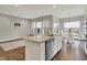 Open concept kitchen with a large island, stainless steel dishwasher, hardwood floors, and bright breakfast area at 6026 Rockdell Dr, Indianapolis, IN 46237