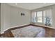Bright living room with hardwood floors and large windows showcasing floral curtains at 6026 Rockdell Dr, Indianapolis, IN 46237