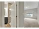 A peek inside the main bedroom with neutral carpet, a large window, and a main bathroom at 6026 Rockdell Dr, Indianapolis, IN 46237
