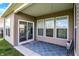 A cozy covered patio with a blue rug, offering an inviting outdoor seating area with natural light at 6026 Rockdell Dr, Indianapolis, IN 46237