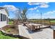 A backyard wooden deck with benches, a firepit and lush landscaping with nice views at 6026 Sally Ann Cir, Indianapolis, IN 46237