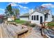A view of a home's backyard with a wooden deck, landscaping and view of a lake at 6026 Sally Ann Cir, Indianapolis, IN 46237