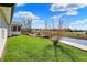 A backyard with a wooden deck, lush green grass, pond and nice view at 6026 Sally Ann Cir, Indianapolis, IN 46237