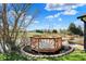 A wooden deck overlooking a pond surrounded by mulch and grass at 6026 Sally Ann Cir, Indianapolis, IN 46237