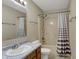 Bathroom with a sink, vanity, toilet, and shower-tub combo with a curtain at 6026 Sally Ann Cir, Indianapolis, IN 46237