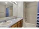 Bright bathroom featuring a double sink vanity and a shower-tub combo with curtain at 6026 Sally Ann Cir, Indianapolis, IN 46237