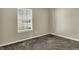 Bright carpeted bedroom with a window offering a view of the outdoors at 6026 Sally Ann Cir, Indianapolis, IN 46237