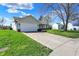 Beautifully maintained home with an attached garage and a long driveway, surrounded by a green lawn at 6026 Sally Ann Cir, Indianapolis, IN 46237