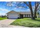 Charming single-story home featuring a two-car garage and a well-maintained front yard with mature trees at 6026 Sally Ann Cir, Indianapolis, IN 46237