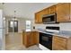 Well-equipped kitchen with wooden cabinets, granite counters, and stainless steel appliances at 6026 Sally Ann Cir, Indianapolis, IN 46237