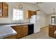 Kitchen featuring stainless steel appliances, wooden cabinets, and a kitchen sink window at 6026 Sally Ann Cir, Indianapolis, IN 46237