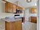 Well-equipped kitchen with wooden cabinets, granite counters, and stainless steel appliances at 6026 Sally Ann Cir, Indianapolis, IN 46237
