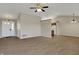 Bright open-concept living space with wood-look flooring, a ceiling fan, and view to the kitchen at 6026 Sally Ann Cir, Indianapolis, IN 46237