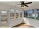 Bright sunroom featuring lots of windows, a ceiling fan, and access to the backyard at 6026 Sally Ann Cir, Indianapolis, IN 46237