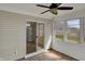 Bright sunroom with a ceiling fan, multiple windows, and a sliding glass door at 6026 Sally Ann Cir, Indianapolis, IN 46237