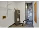 A utility room featuring a water heater, furnace, tile flooring and shelving for storage at 6026 Sally Ann Cir, Indianapolis, IN 46237