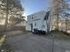 The backyard has a concrete pad and offers convenient parking and a view of the home's rear entrance at 614 E 5Th St, Anderson, IN 46012