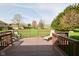 Back deck with chairs overlooking a large green lawn at 6276 Quail Rdg W Dr, Plainfield, IN 46168