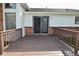 A spacious wooden deck with brown railings is attached to this home with a sliding glass door at 6276 Quail Rdg W Dr, Plainfield, IN 46168