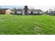 This expansive backyard features a well-manicured lawn, perfect for recreation and entertaining, with a small deck at 6276 Quail Rdg W Dr, Plainfield, IN 46168