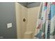 Bathroom showing a shower with shower curtain and tan colored shower stall at 6276 Quail Rdg W Dr, Plainfield, IN 46168