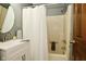 Bathroom with white shower curtain and vanity featuring a round mirror at 6276 Quail Rdg W Dr, Plainfield, IN 46168