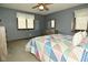 Bedroom with a colorful patchwork quilt, two windows, and neutral carpet at 6276 Quail Rdg W Dr, Plainfield, IN 46168