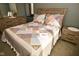 Bedroom with a decorative patchwork quilt and dresser and bedside table set at 6276 Quail Rdg W Dr, Plainfield, IN 46168